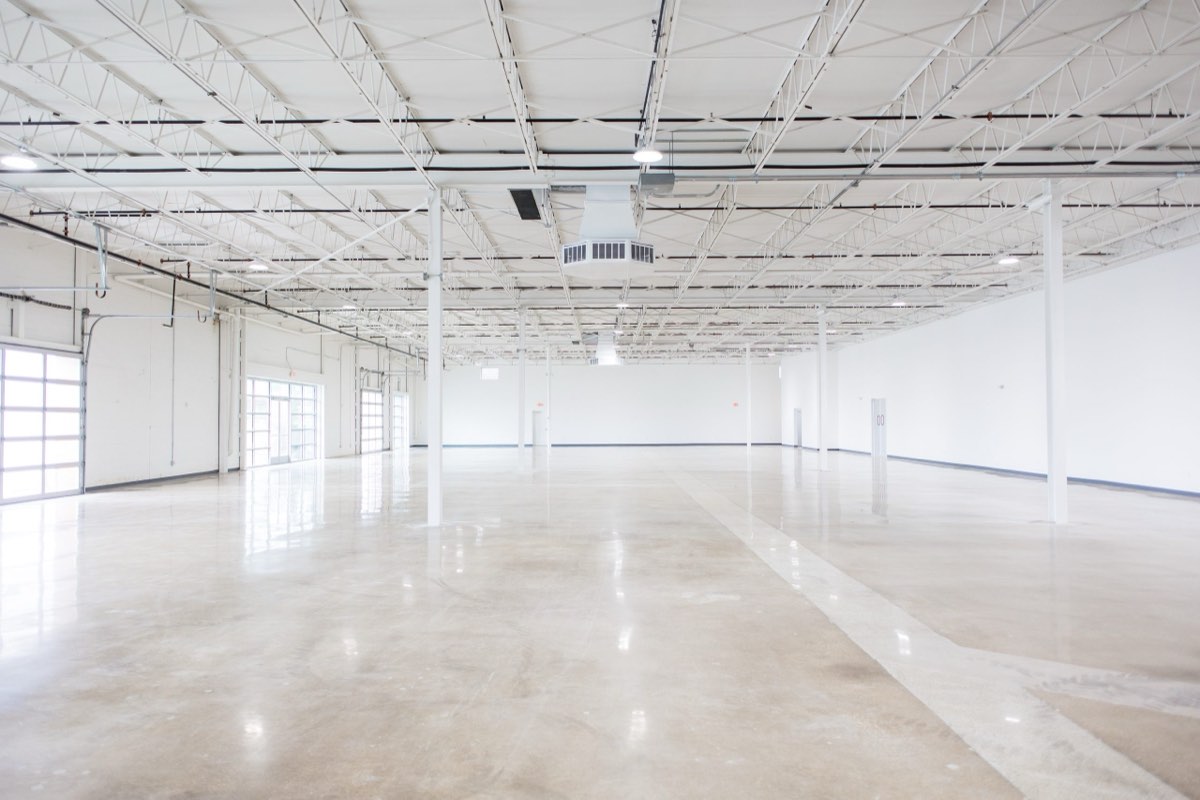 The empty 12,500 sqft main hall at Astoria Event Venue — polished floors and 18-ft ceilings