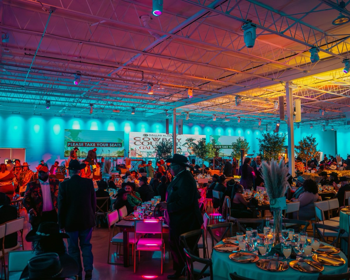 Full gala floor at Astoria Event Venue glowing in teal and amber uplighting